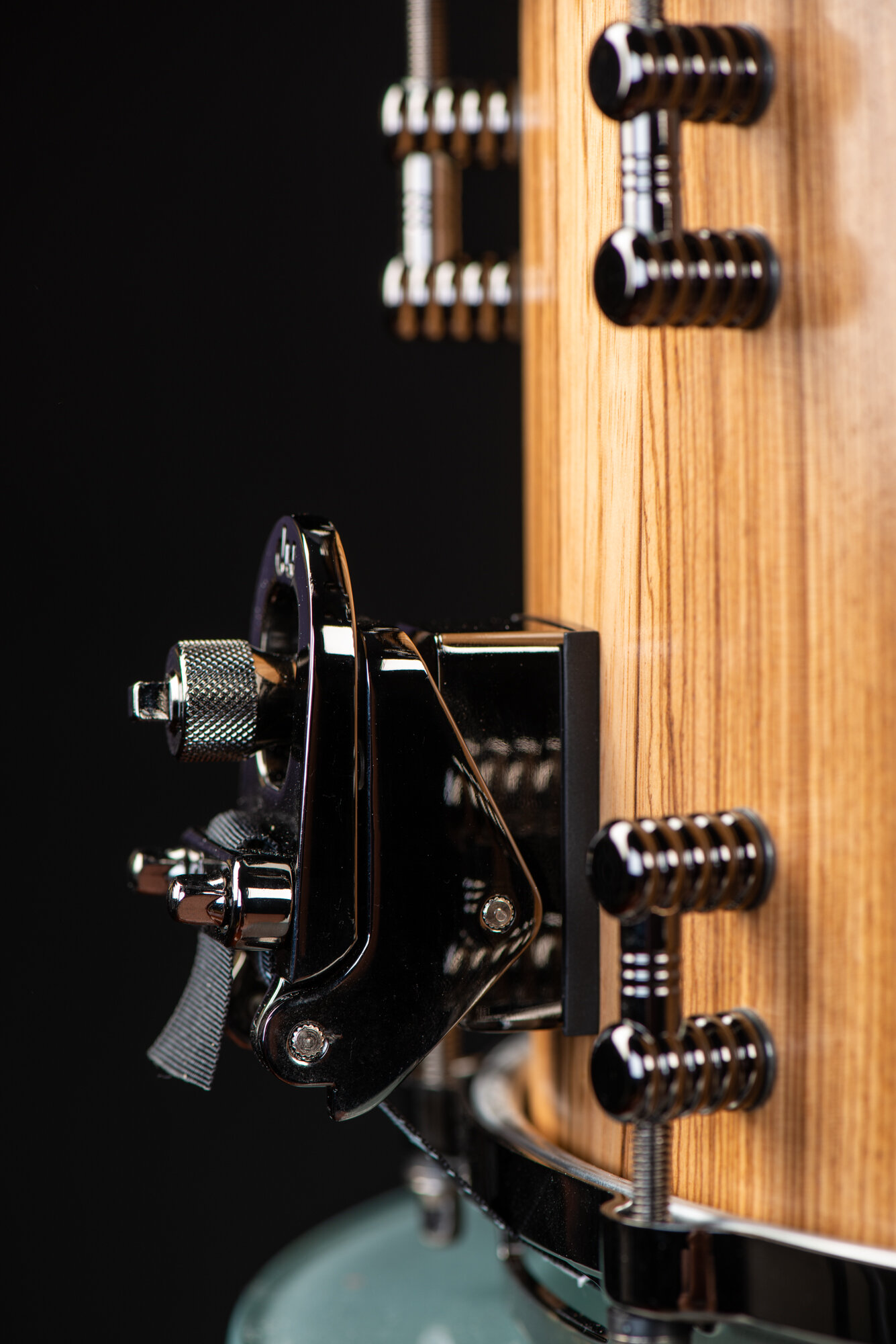 Natural wood snare drum with a clear finish, featuring a black nickel snare throw-off and ribbed metal lugs.