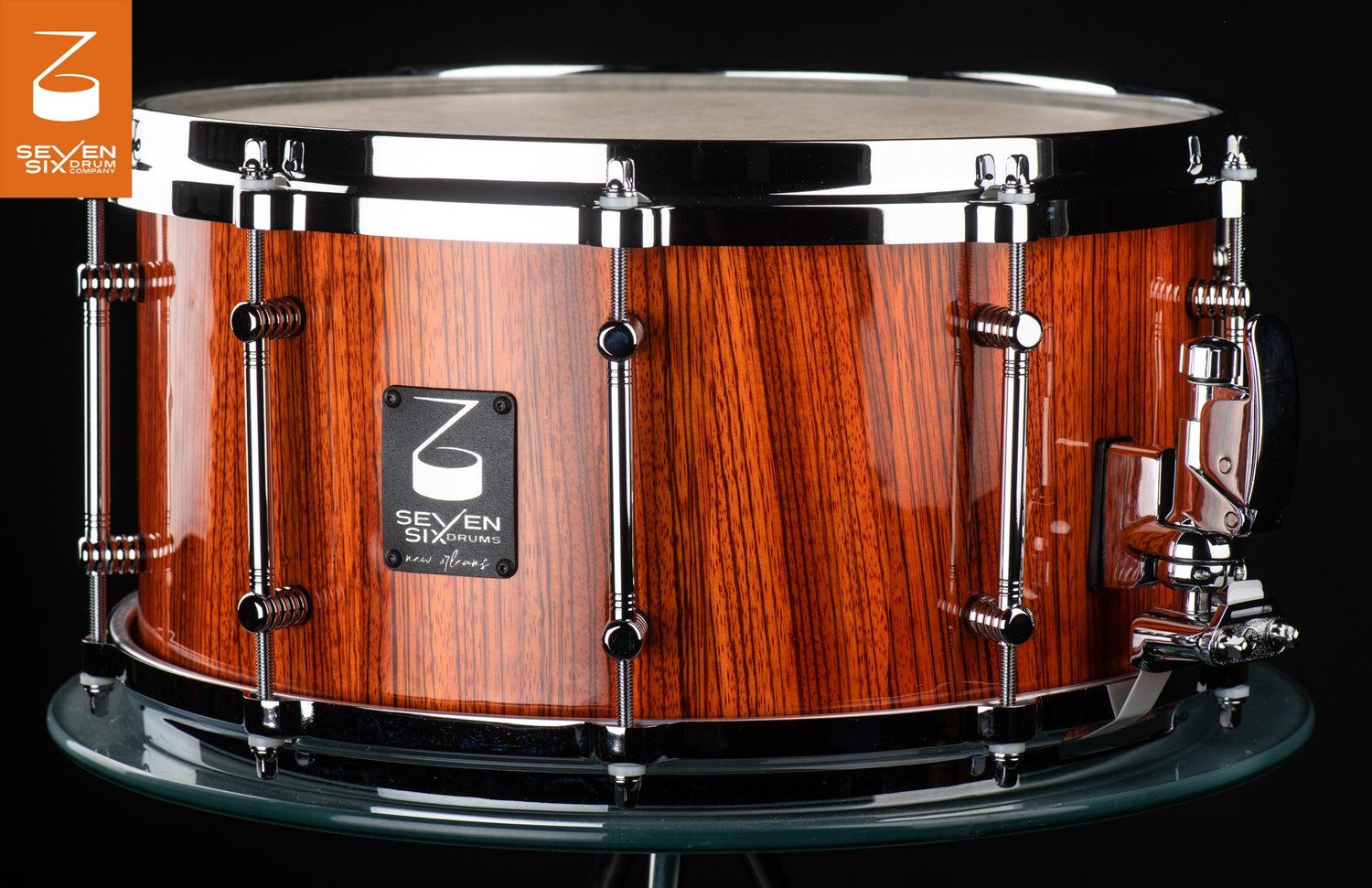 Handmade snare drum with a glossy vertical-grain wood shell, chrome tube lugs, and polished chrome hardware.