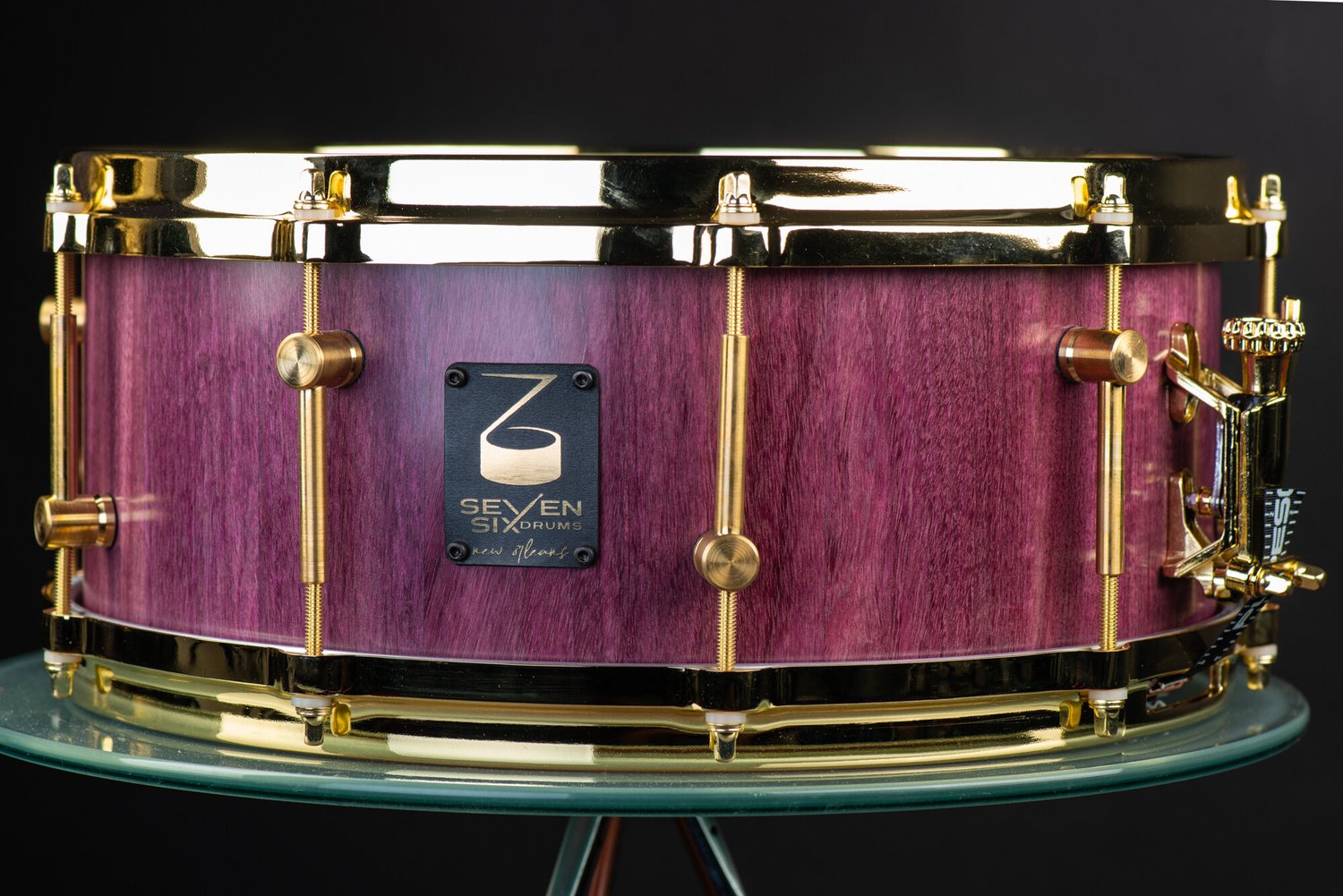Handcrafted purpleheart wood snare drum with a satin finish, gold-plated hoops, and brushed brass lugs.