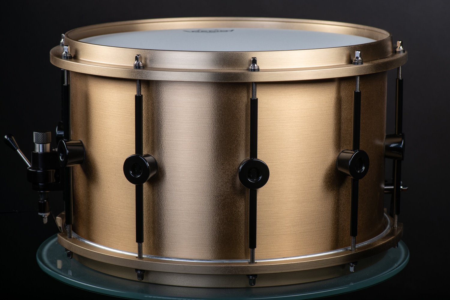 Cast bronze custom snare drum with custom black lugs