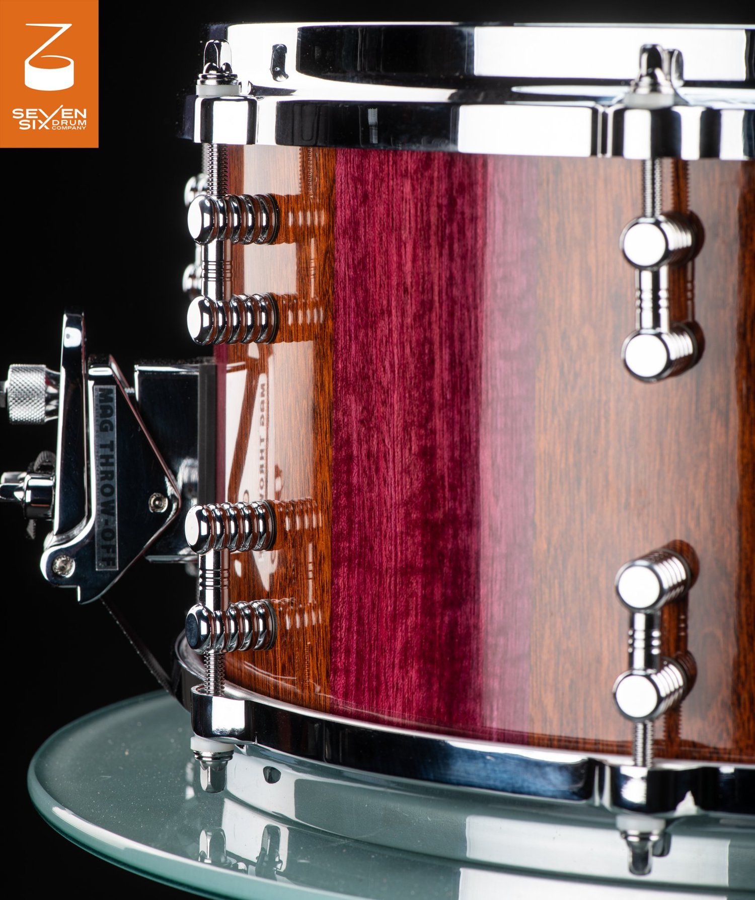 Handmade snare drum in glossy purple and brown wood, featuring chrome lugs and a Mag Throw-Off strainer.