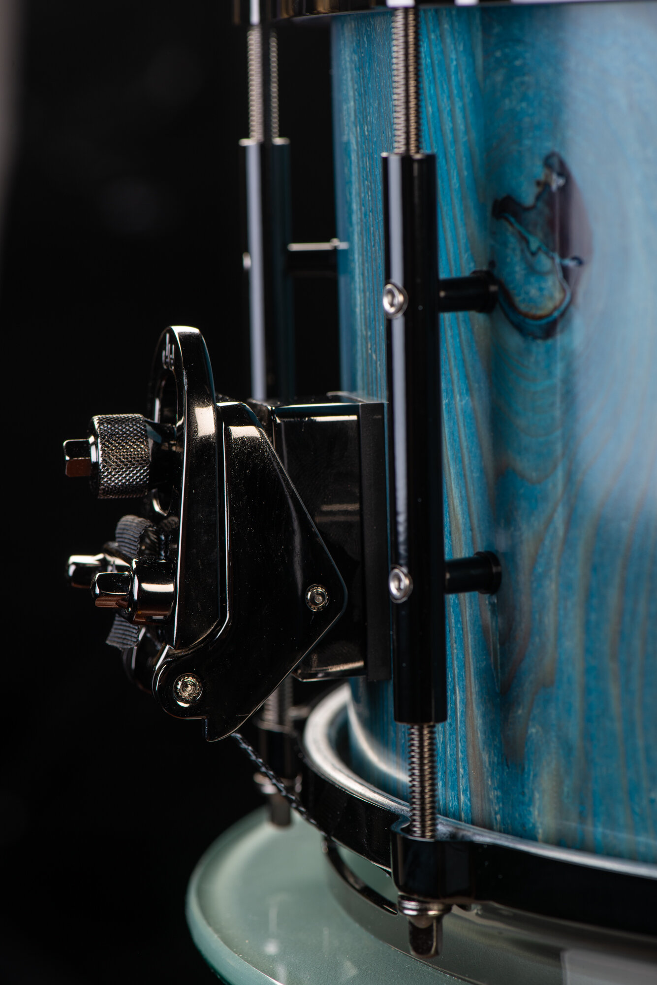 Handmade snare drum with a blue-stained wood shell, black nickel throw-off, and sleek black lugs.