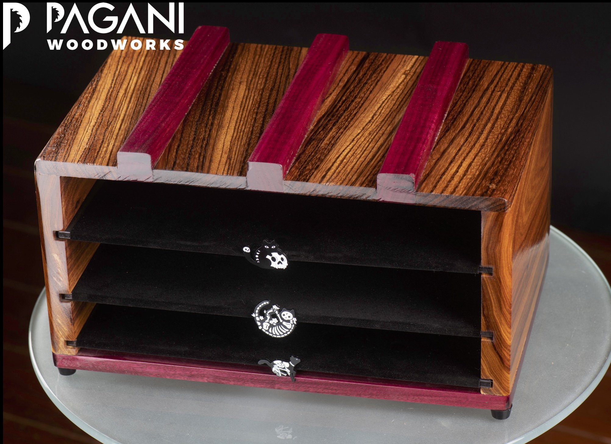 Glossy striped wood and purpleheart organizer box with black velvet trays and skeleton cat pulls.