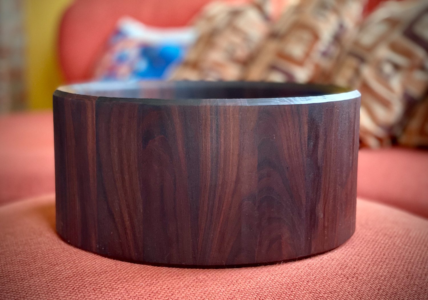 A dark hardwood stave snare drum shell with a smooth satin finish and beveled bearing edges, shown without hardware.