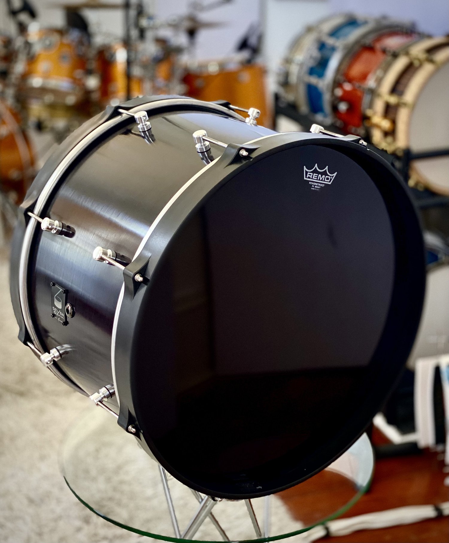 Bass drum featuring a brushed black metal shell, matte black hoops, and chrome lugs.