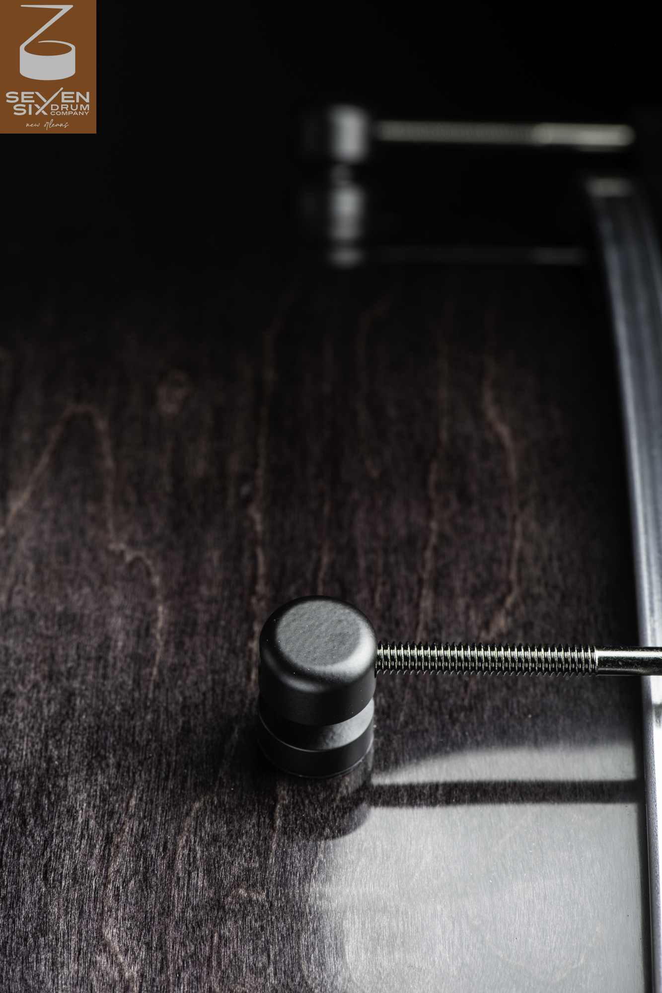 Dark-stained wood snare drum shell with a satin finish, featuring a matte black lug and threaded tension rod.