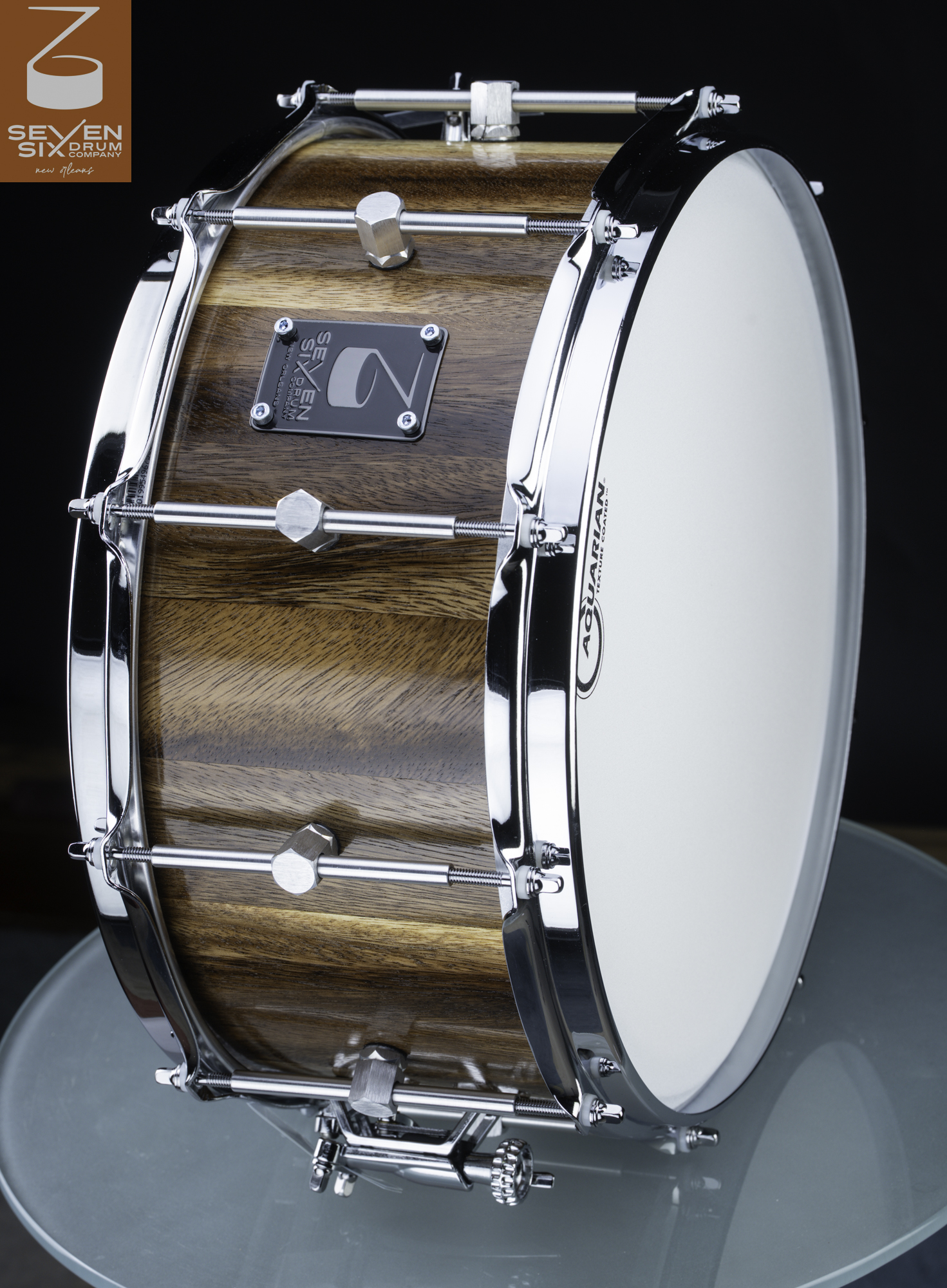 Handmade snare drum with a natural gloss wood shell, chrome hoops, hex lugs, and a white coated drumhead.