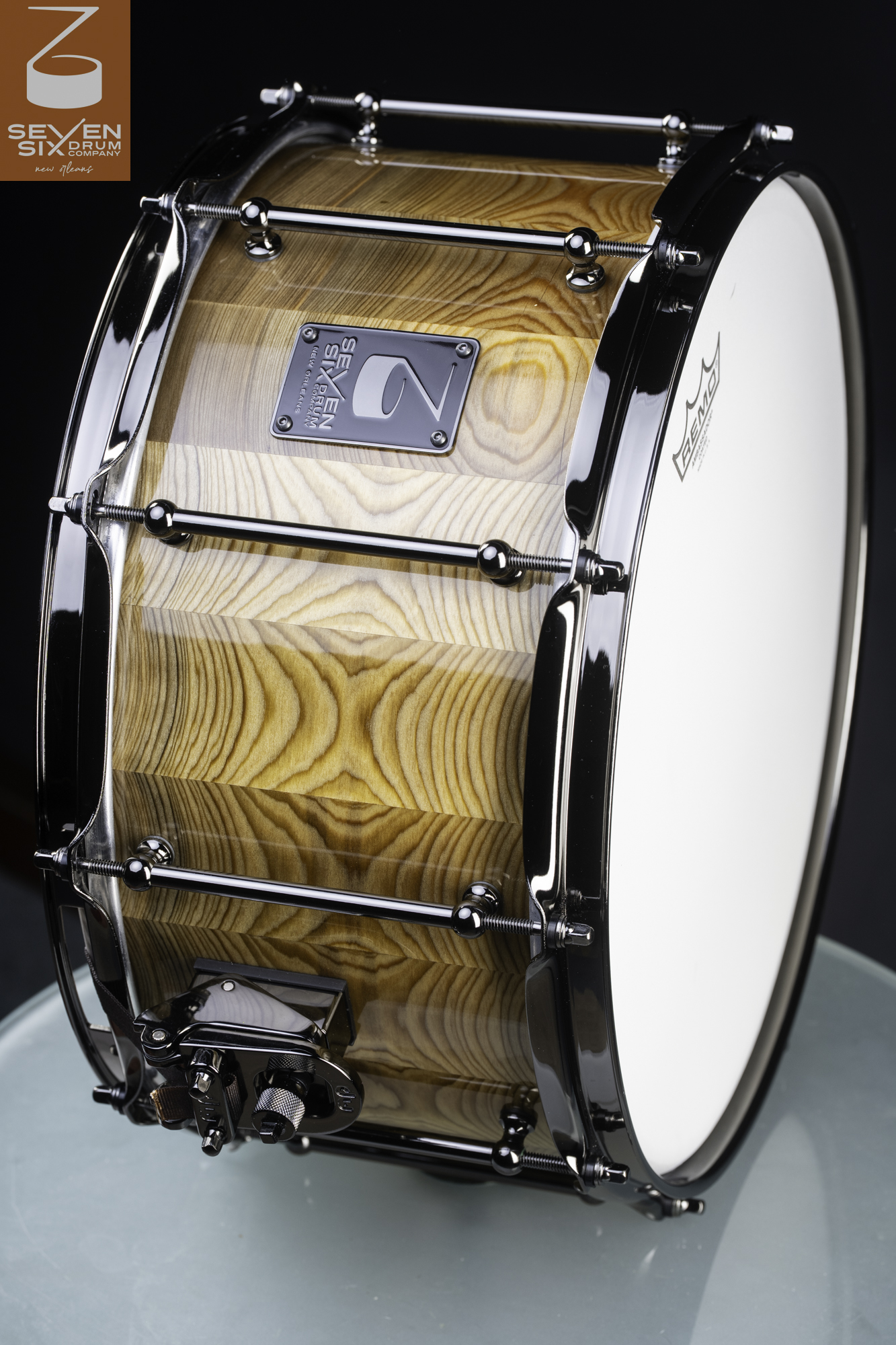 Handcrafted stave wood snare drum featuring a gloss natural finish, black nickel tube lugs, and a DW throw-off.