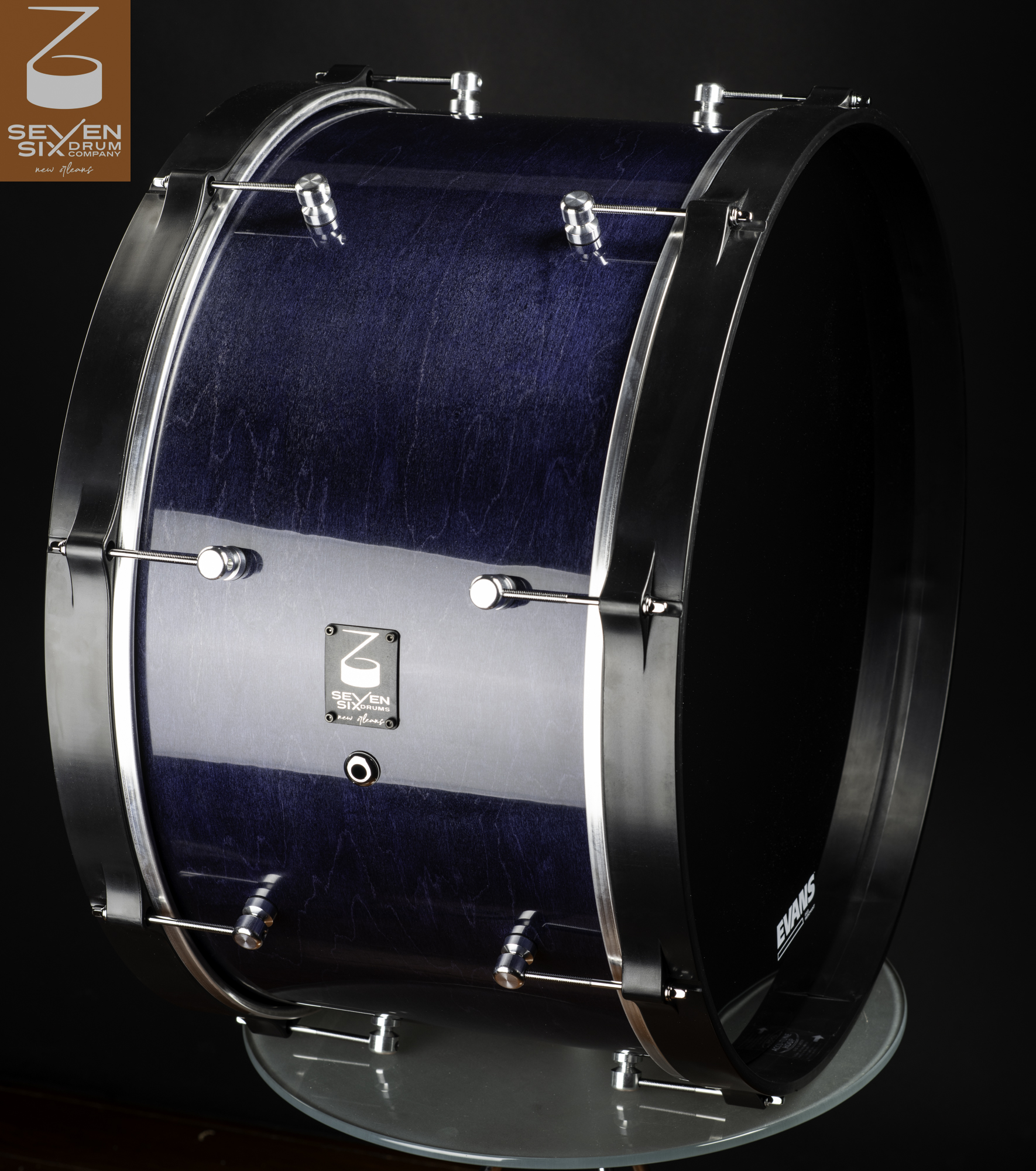 Handmade ultralight maple bass drum with a gloss blue stained wood shell, matte black hoops, and polished chrome lugs.