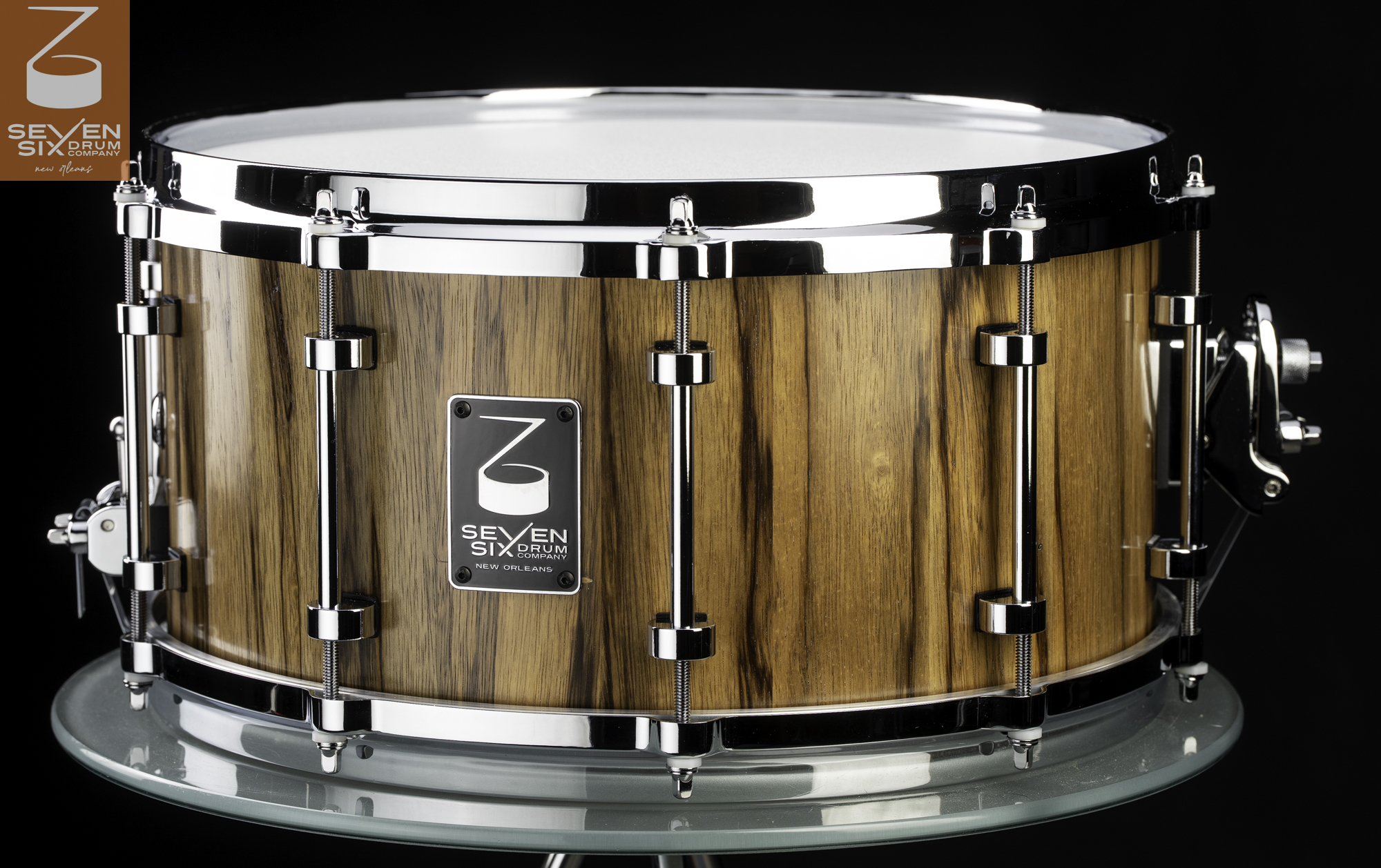 Handmade Black Limba snare drum featuring a natural striped wood shell, polished chrome tube lugs, and chrome hoops.