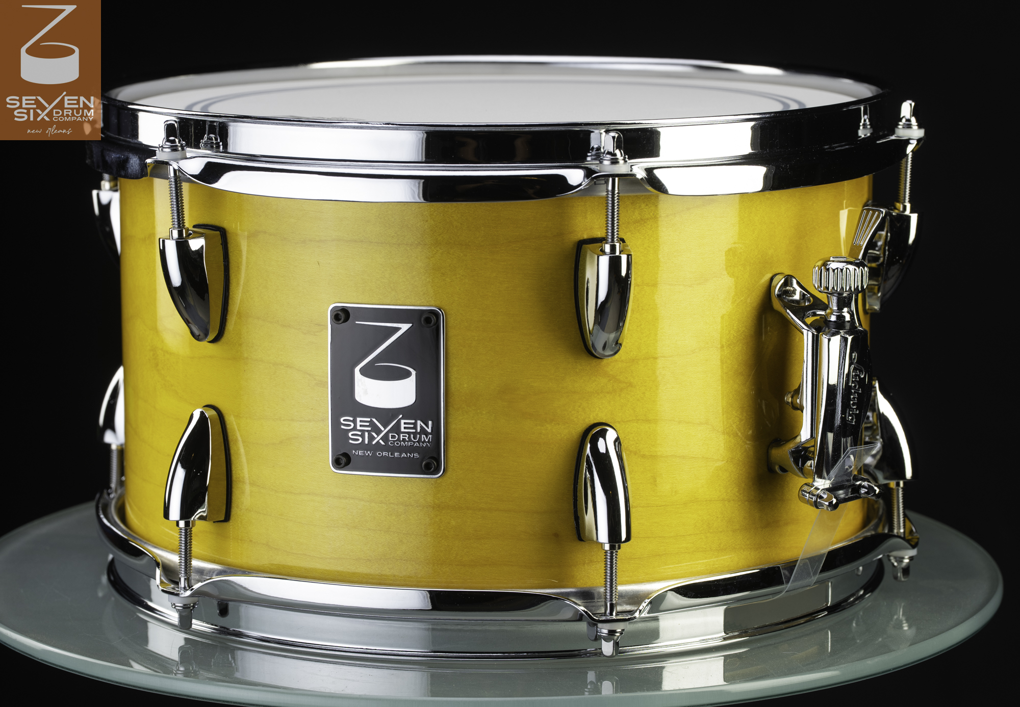 Handmade Maple snare drum with a glossy yellow wood shell, chrome lugs, and a chrome snare throw-off.
