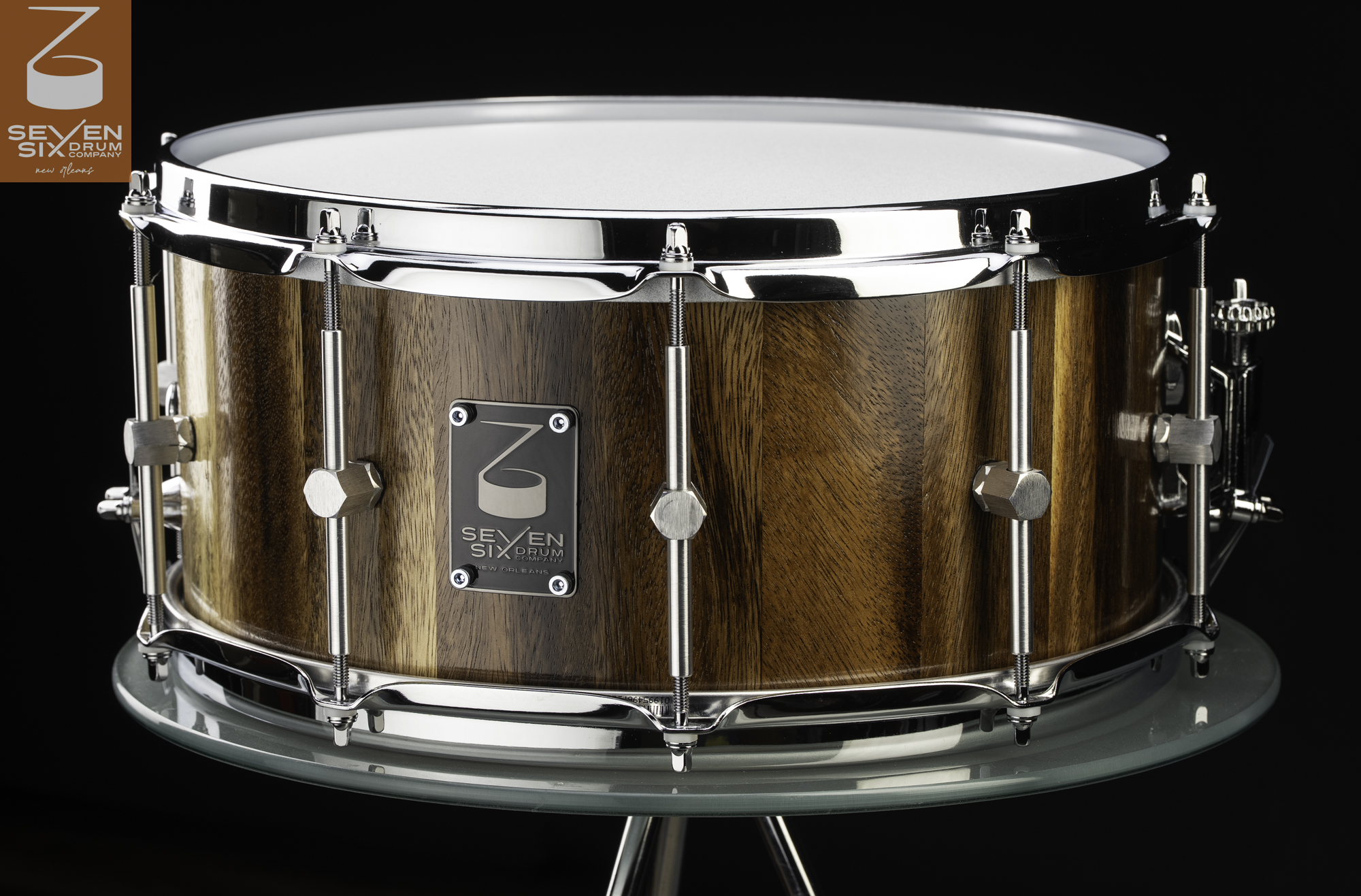 Handmade Monkeypod wood stave snare drum featuring a natural satin finish, polished chrome rims, and sleek center-mounted lugs.